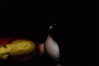 A Clown With A Red Nose Is Laying Down On The Ground GIF