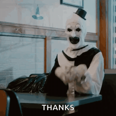A Clown With A Top Hat Is Sitting At A Table With The Words Thanks Behind Him GIF