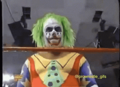 A Clown With Green Hair And A Skull Face Paint GIF