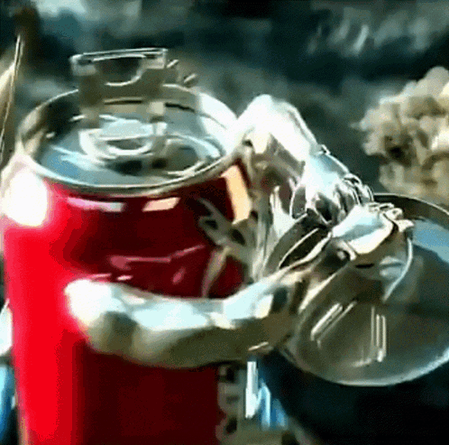 A Coca Cola Can Is Being Held By A Robotic Arm GIF
