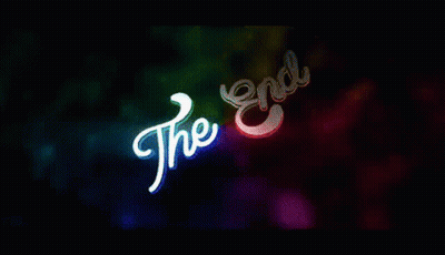 A Colorful Background With The Words `` The End '' Glowing In The Dark . GIF