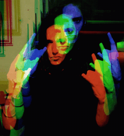 A Colorful Image Of A Person Making A Horns Sign GIF