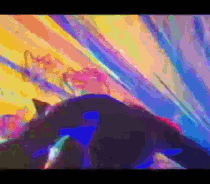 A Colorful Painting Of A Cat Laying On The Ground GIF