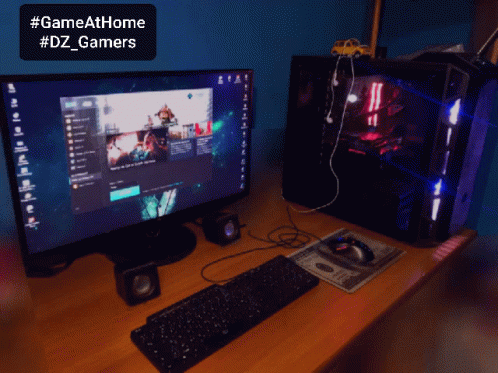 A Computer With A Keyboard And Mouse On A Desk With A Sign That Says Gameathome #Dz_gamers GIF