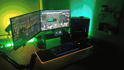 A Computer With Two Monitors And A Clock That Says 11:59 On It GIF