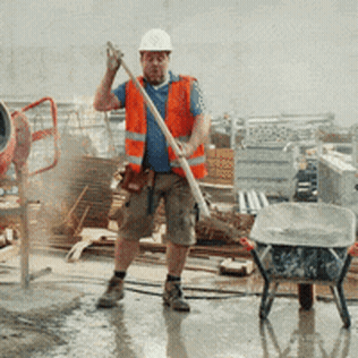 A Construction Worker Wearing A Hard Hat And Safety Vest GIF