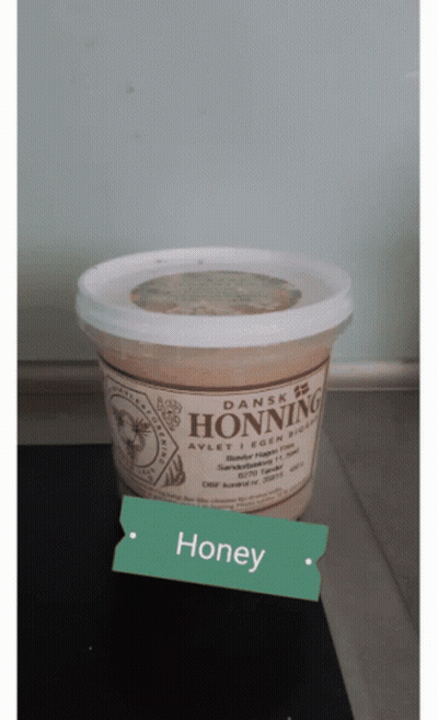 A Container Of Dansk Honning Is Sitting On A Table GIF