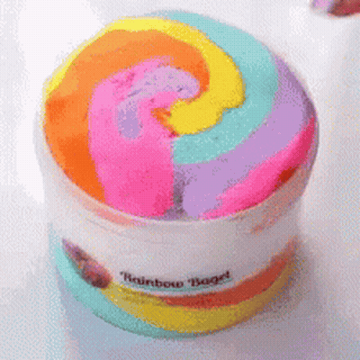 A Container Of Rainbow Bagel Slime With A Swirl In The Middle GIF