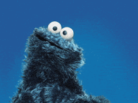 A Cookie Monster From Sesame Street Is Smiling And Looking At The Camera GIF