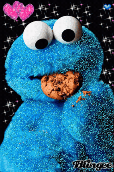 A Cookie Monster Is Eating A Cookie With Hearts In The Background GIF