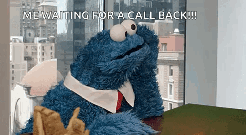 A Cookie Monster Is Sitting At A Desk Waiting For A Call Back .. GIF