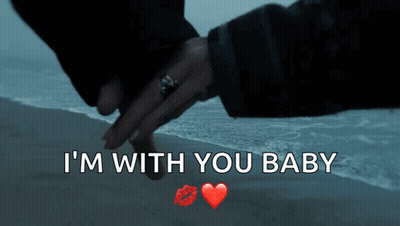 A Couple Holding Hands On A Beach With The Words I 'M With You Baby GIF