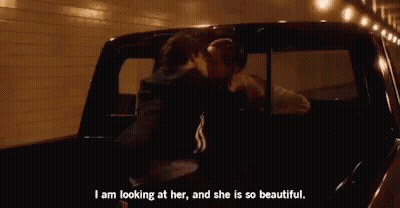 A Couple Is Kissing In The Back Of A Truck . GIF