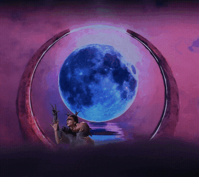A Couple Kissing In Front Of A Blue Moon GIF