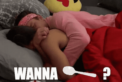 A Couple Laying In Bed With The Word Wanna On The Bottom Right GIF