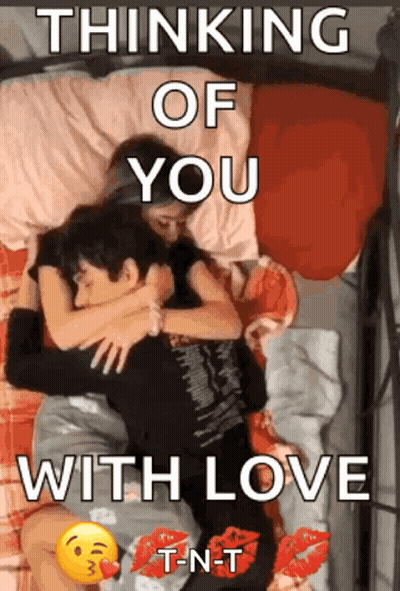 A Couple Laying On A Bed With The Words " Thinking Of You With Love " On The Bottom GIF