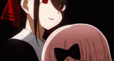 A Couple Of Anime Girls Are Standing Next To Each Other And Looking At Each Other . GIF