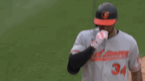 A Couple Of Baseball Players Are Hugging Each Other On The Field . GIF