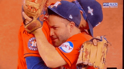A Couple Of Baseball Players Hugging Each Other With The Fs1 Alcs Series Tied 2-2 GIF