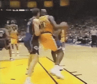 A Couple Of Basketball Players Are Fighting On A Court . GIF