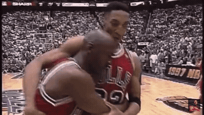 A Couple Of Basketball Players Are Hugging Each Other On A Court . GIF