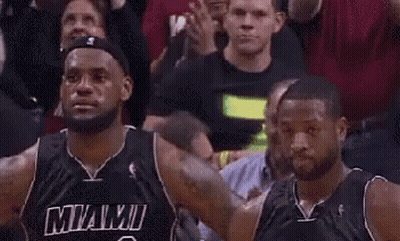 A Couple Of Basketball Players Are Standing Next To Each Other In A Crowd . GIF