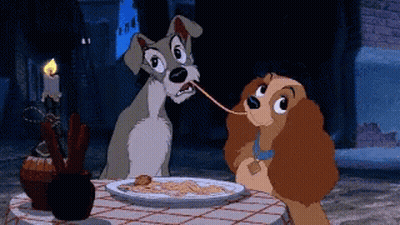 A Couple Of Cartoon Dogs Are Eating Spaghetti At A Table GIF