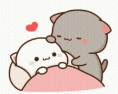 A Couple Of Cats Are Sitting On Top Of A Bed . GIF