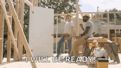 A Couple Of Construction Workers Are Sitting On A Stool In Front Of A House Under Construction . GIF