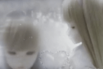 A Couple Of Dolls Are Standing Next To Each Other And Looking At Each Other . GIF