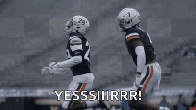 A Couple Of Football Players Are Running On A Field And One Of Them Is Saying Yes . GIF