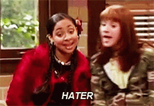 A Couple Of Girls Are Standing Next To Each Other And One Of Them Is Saying Hater . GIF