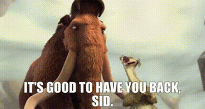 A Couple Of Mammoths Standing Next To Each Other With The Words `` It 'S Good To Have You Back , Sid '' . GIF