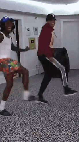 A Couple Of Men Are Dancing In A Room . GIF