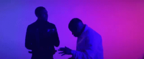 A Couple Of Men Are Dancing In Front Of A Purple And Blue Background . GIF