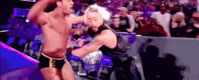 A Couple Of Men Are Fighting In A Wrestling Ring . GIF