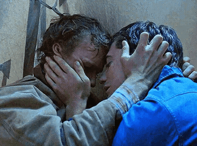 A Couple Of Men Are Hugging Each Other And One Of Them Is Covering His Face With His Hands . GIF