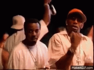 A Couple Of Men Are Standing Next To Each Other In A Crowd . GIF