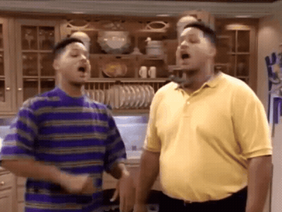 A Couple Of Men Are Standing Next To Each Other In A Kitchen . GIF
