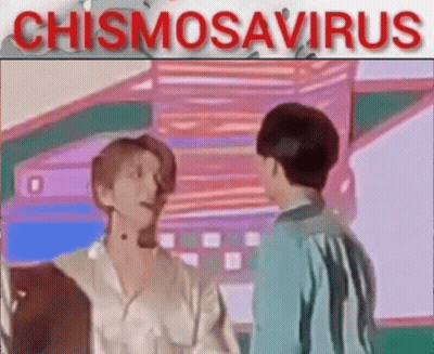 A Couple Of Men Are Standing Next To Each Other In A Room And Talking To Each Other . GIF