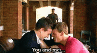 A Couple Of Men Kissing With The Words You And Me Behind Them GIF