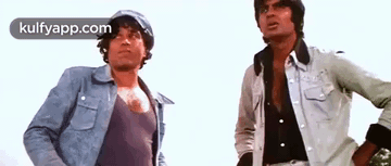 A Couple Of Men Standing Next To Each Other . GIF