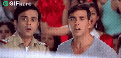 A Couple Of Men Standing Next To Each Other In Front Of A Crowd . GIF