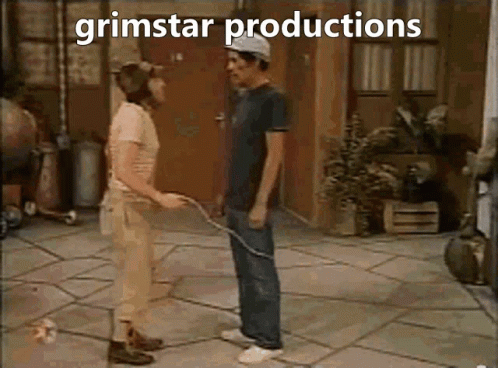 A Couple Of Men Standing Next To Each Other With The Words Grimstar Productions Written Above Them GIF