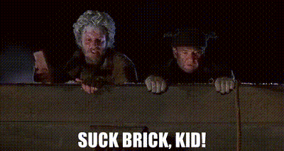 A Couple Of Men Standing Next To Each Other With The Words Suck Brick Kid Written On The Bottom . GIF