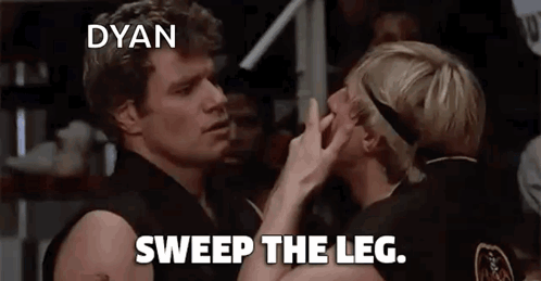 A Couple Of Men Standing Next To Each Other With The Words Sweep The Leg On The Bottom GIF