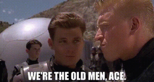 A Couple Of Men Standing Next To Each Other With The Words `` We 'Re The Old Men , Ace '' . GIF