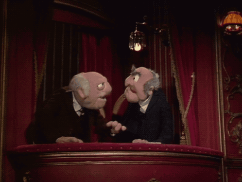 A Couple Of Muppets Are Sitting On A Balcony Talking To Each Other GIF