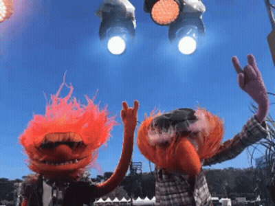 A Couple Of Muppets Giving The Horns Sign With Their Hands GIF