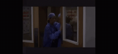 A Couple Of Nurses Are Standing Next To Each Other In A Room . GIF